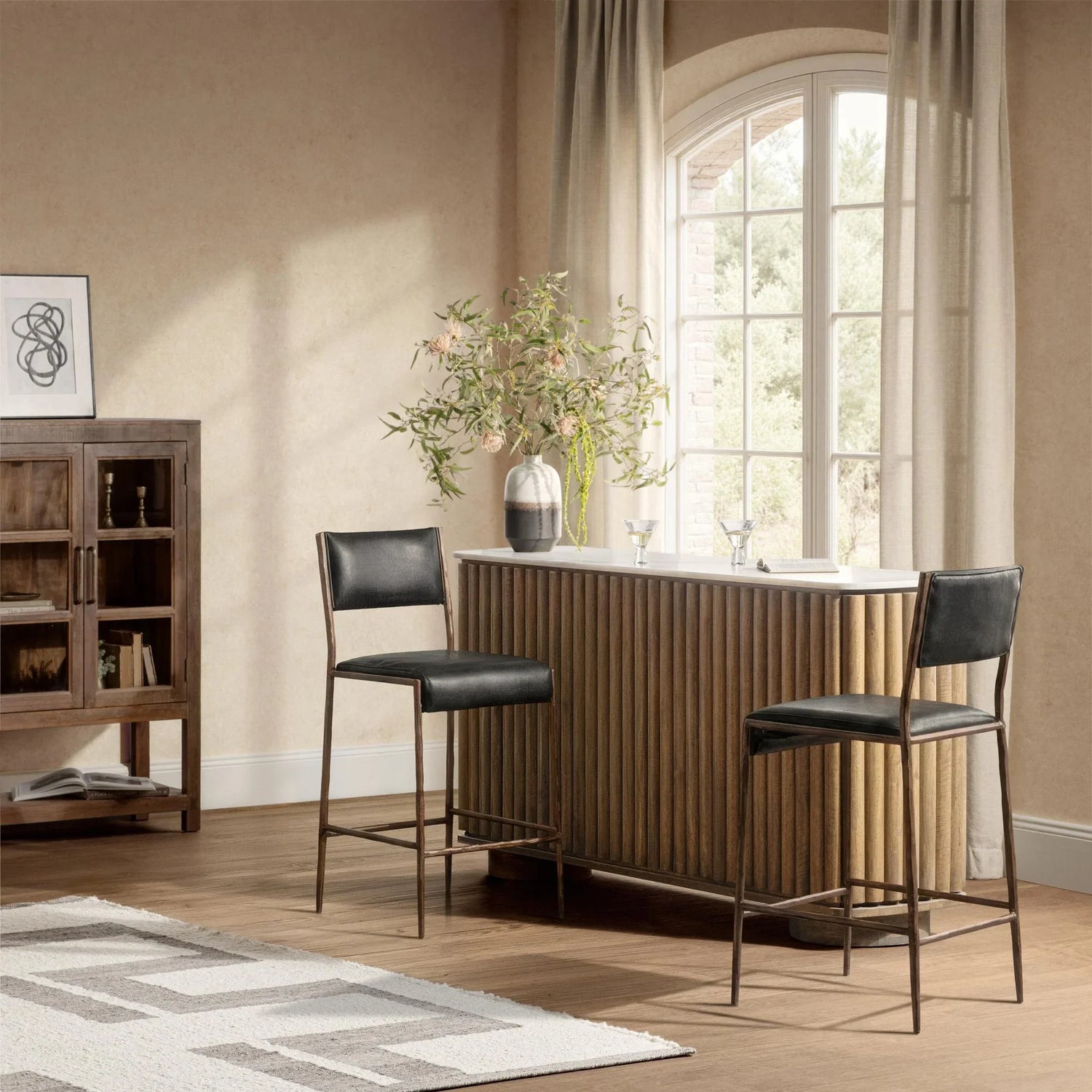 Modern rustic dining room with a wood sideboard, dining table, upholstered chairs, and black pendant lights