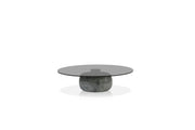 Round glass coffee table with stone base on a white background