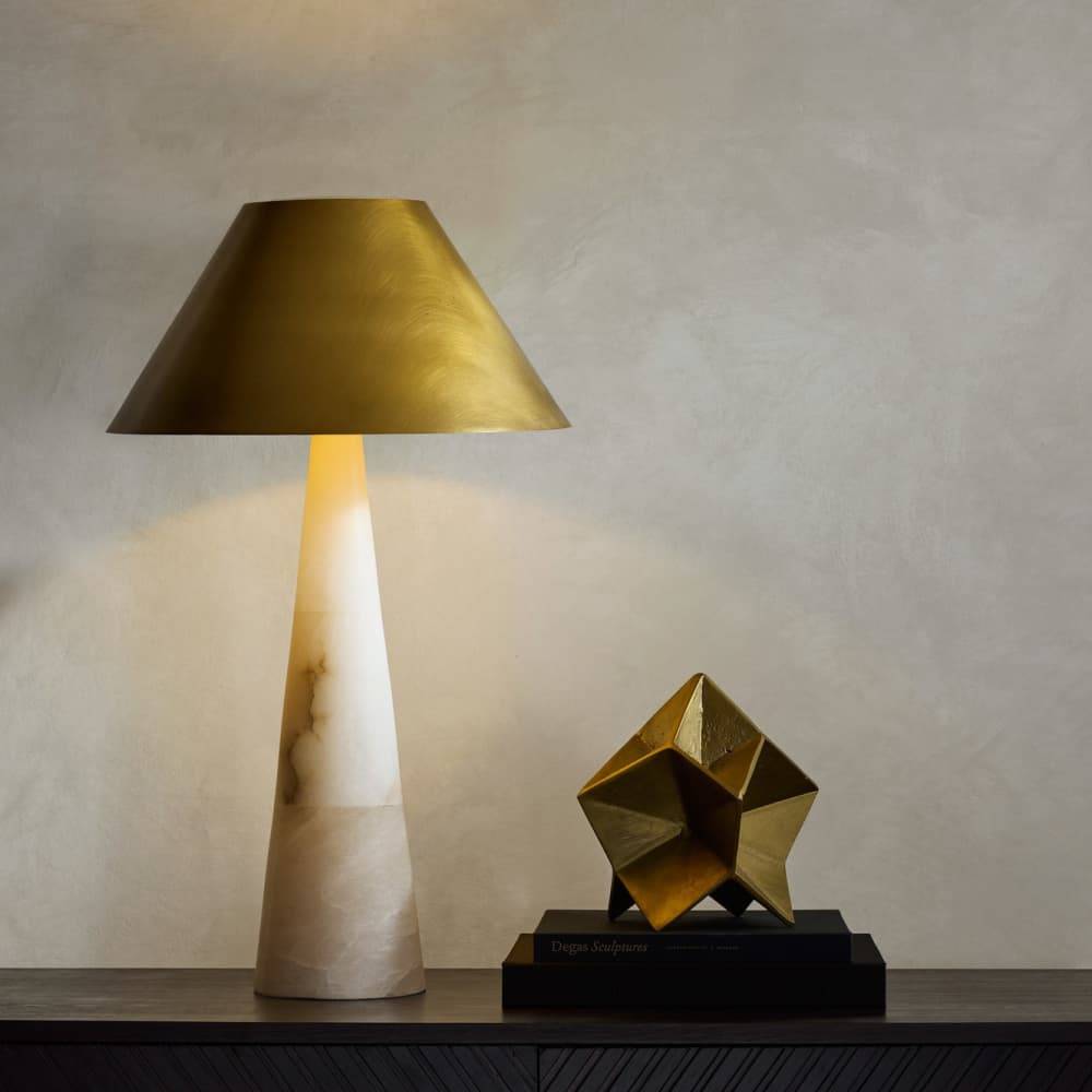 Chanell alabaster table lamp styled on a console with a decorative sculpture